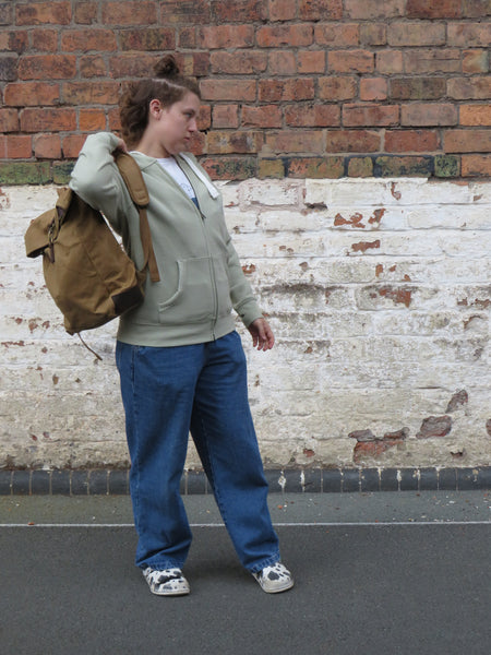 Model wearing Wild isle waxed canvas sand roll top back pack 