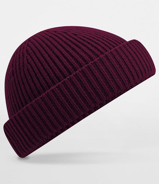 A dark burgundy ribbed knit beanie hat shown at an angle on a light gray background.