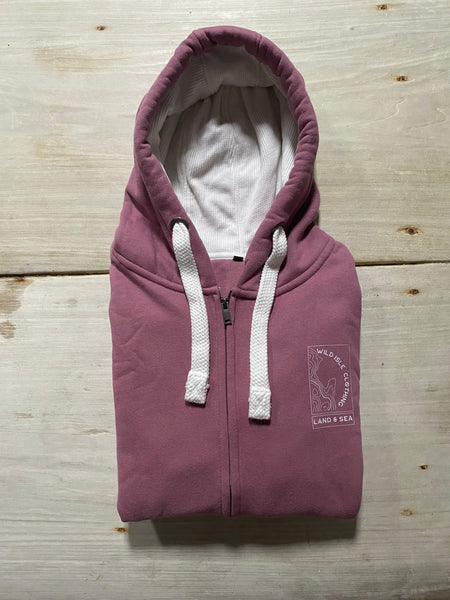 Sunset Pink Wild Isle Trail Zip Up Hoodie folded on a wooden table.