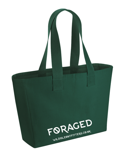 A wild isle forest green canvas tote bag with two shoulder straps and white printed text reading 'FORAGED' and website