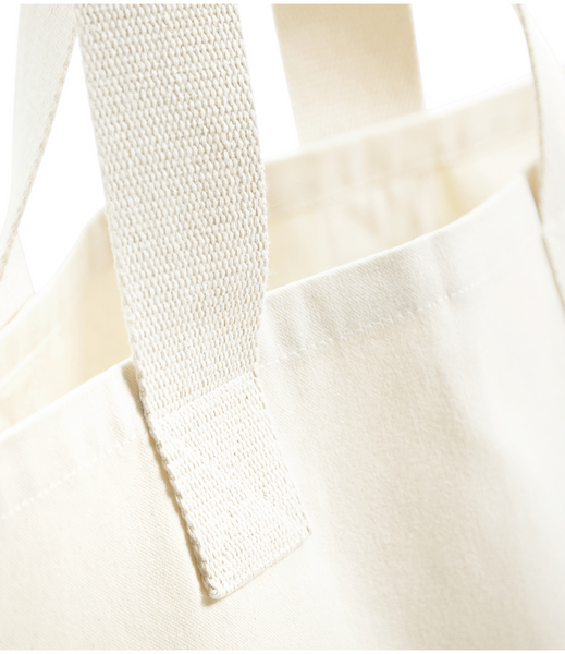 A close up of the wild isle foraged cotton tote bag showing the webbing straps