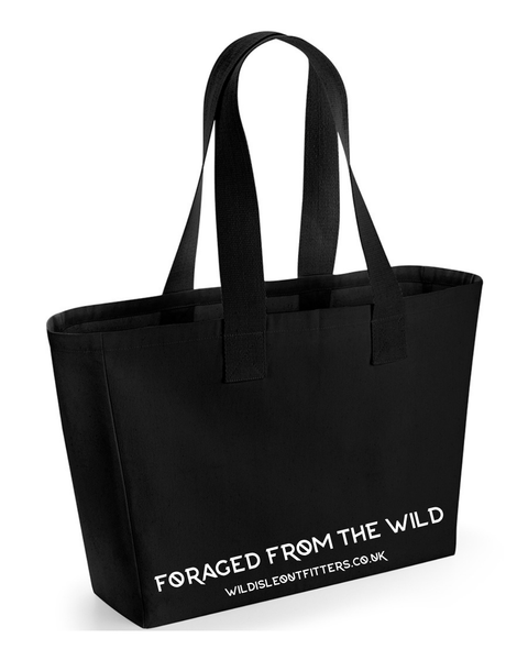 A black canvas tote bag with two shoulder straps, featuring the words Foraged from the Wild and website printed in white on the front, set against a plain white background.