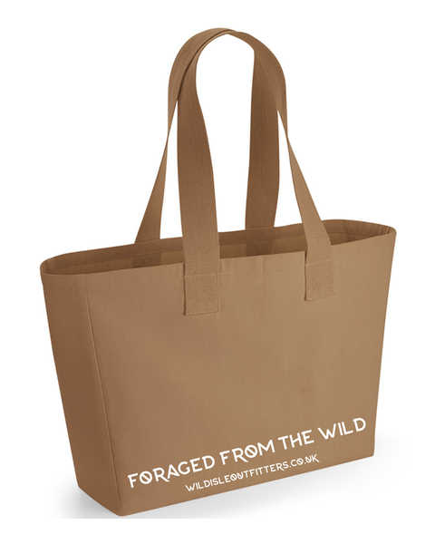 A Wild Isle Sand canvas tote bag with two shoulder straps and white printed text reading 'FORAGED FROM THE WILD' 