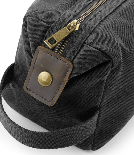 Wild Isle Waxed Canvas Wash Bag in black showing carry strap and popper fitting 