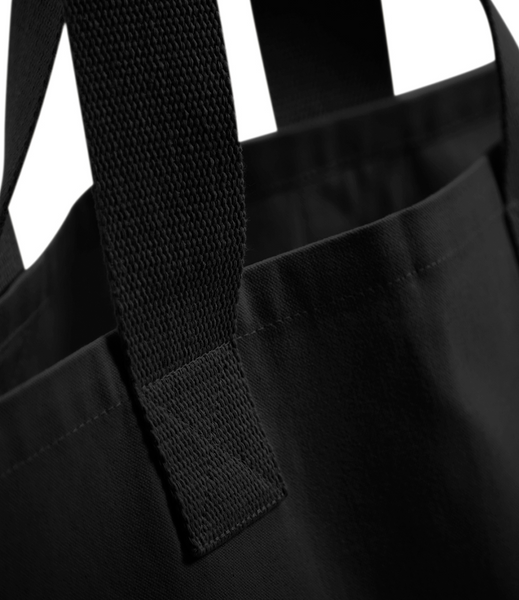 The wild isle black tote bag showing the handle in detail