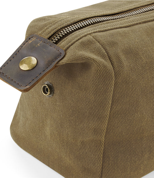 Close up of the wild isle waxed canvas sand wash bag popper closure 