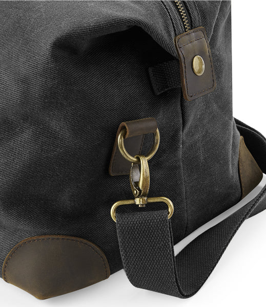 Wild isle Black cabin bag  with brown leather accents showing the carry handle
