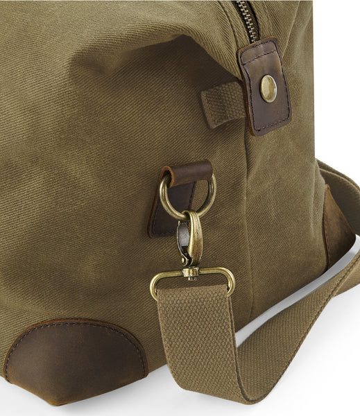 Wild isle waxed canvas cabin bag in sand showing the carry strap attachment 